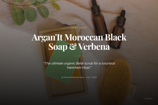 A glass jar of Argan'It Organic Moroccan Black Soap with Argan Oil & Verbena next to a wooden