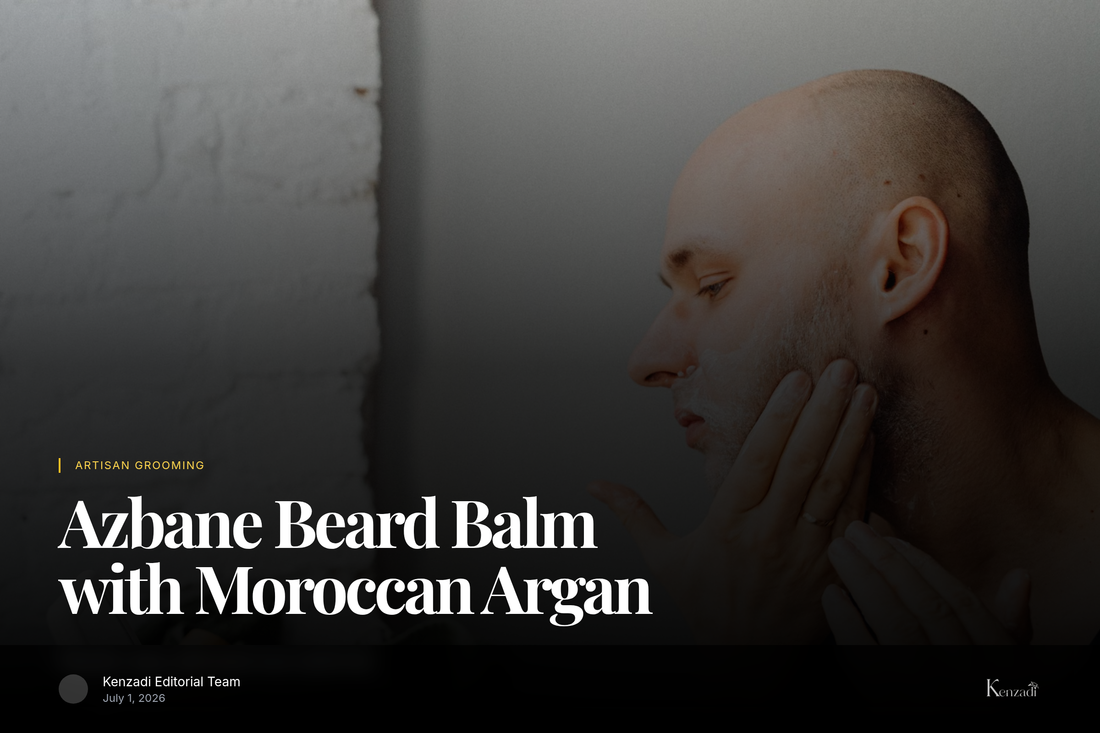 Close-up of a man's hands applying beard balm to a full, well-shaped beard, with a jar of Azbane