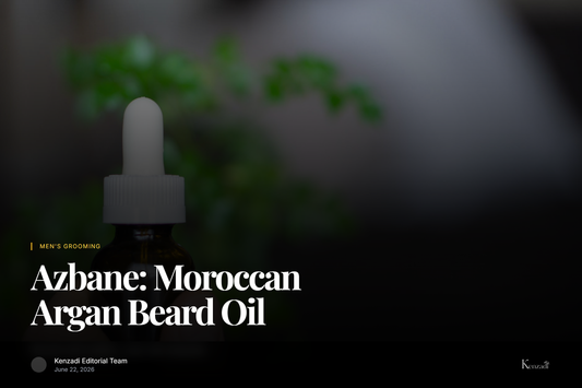 Close-up of a dropper bottle of Azbane Tobacco & Patchouli beard oil next to a mature argan nut