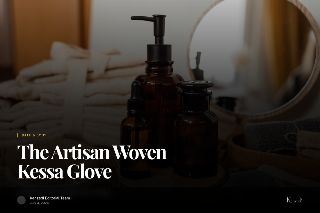 A traditionally woven beige Moroccan Kessa exfoliating glove resting on a stack of white linen towels with a