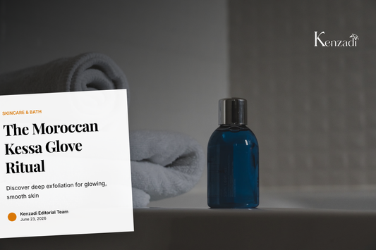 A hand holding a traditional beige Moroccan Kessa exfoliating glove against a backdrop of spa-like towels and greenery